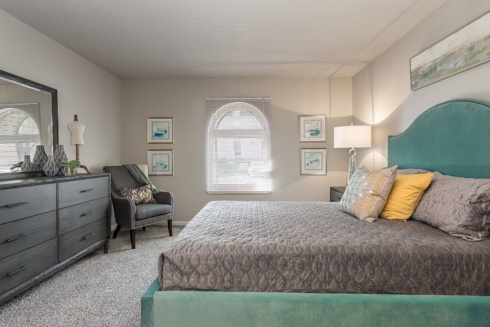 Well lit fully furnished bedroom with front facing window Hickory Creek Apartments & Townhomes in Nashville, Tennessee