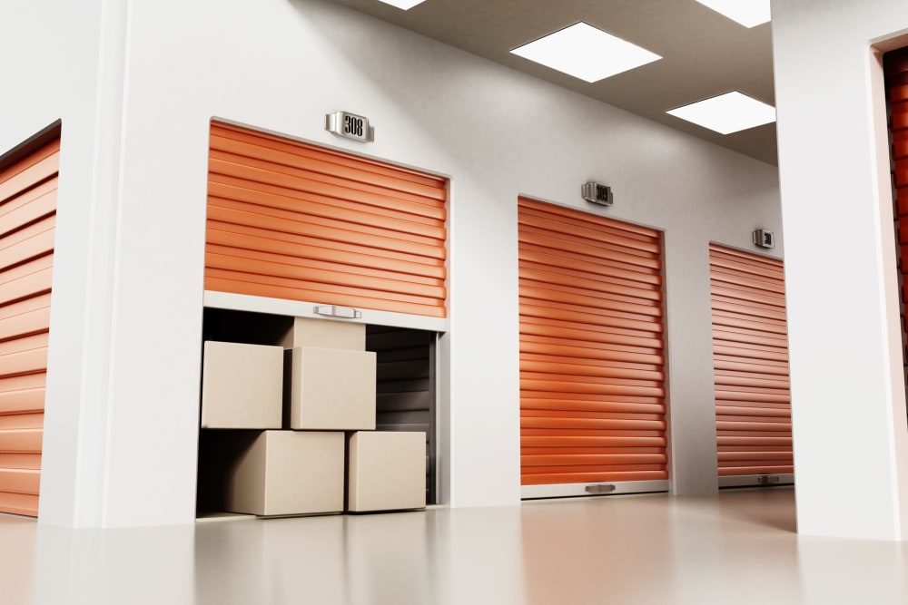 boxes peeking out of a unit with an orange door at Trojan Storage of Marysville in Marysville, Washington