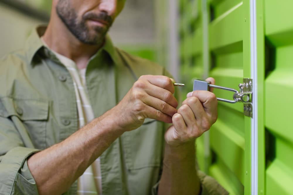 a customer locking a unit at Trojan Storage of Shoreline in Shoreline, Washington