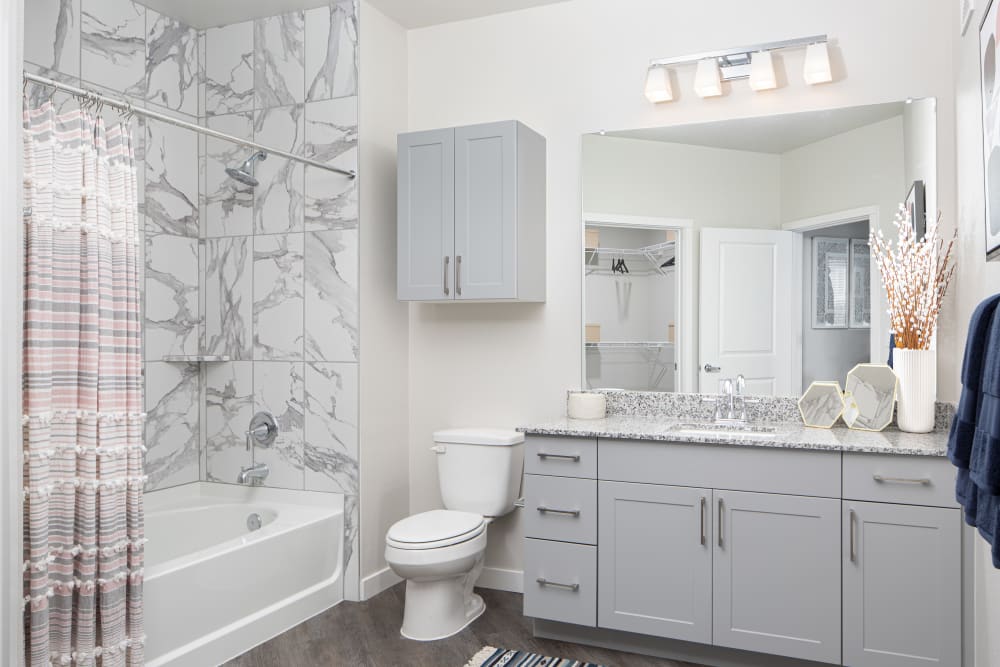 Model bathroom with granite tile and countertops at Bellrock Memorial in Houston, Texas