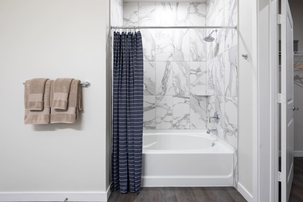 Shower with marble tiles at Bellrock Memorial in Houston, Texas