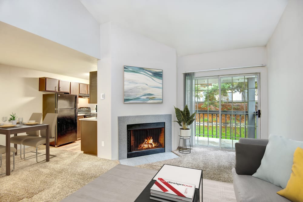 A spacious living room and dining room with private patio access at Wellington Apartment Homes in Silverdale, Washington