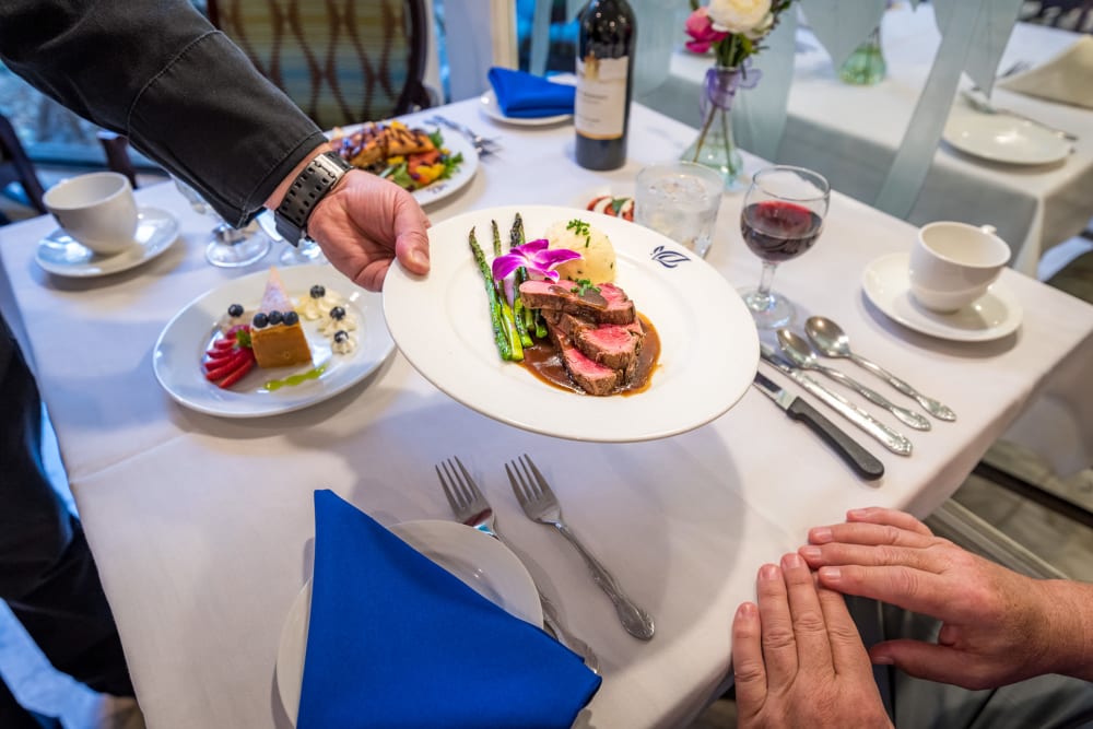 Dining table and food at Pacifica Senior Living Forest Trace in Lauderhill, Florida