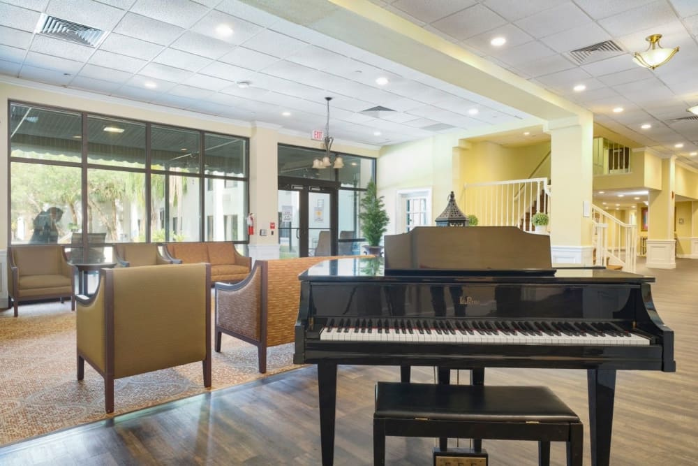 Community center with piano at Grand Villa of Boynton Beach in Boynton Beach, Florida