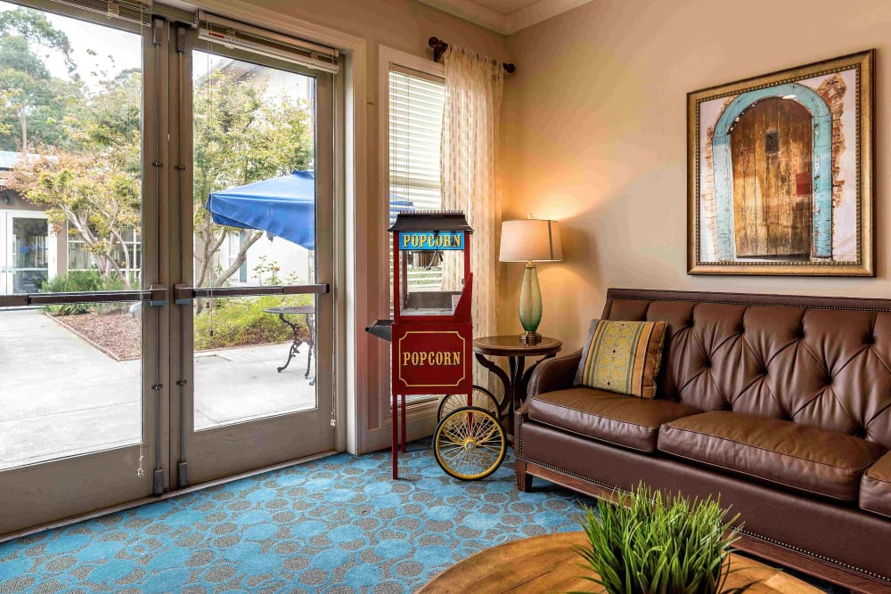 Lounge area with popcorn machine at Pacifica Senior Living Mission Villa in Daly City, California