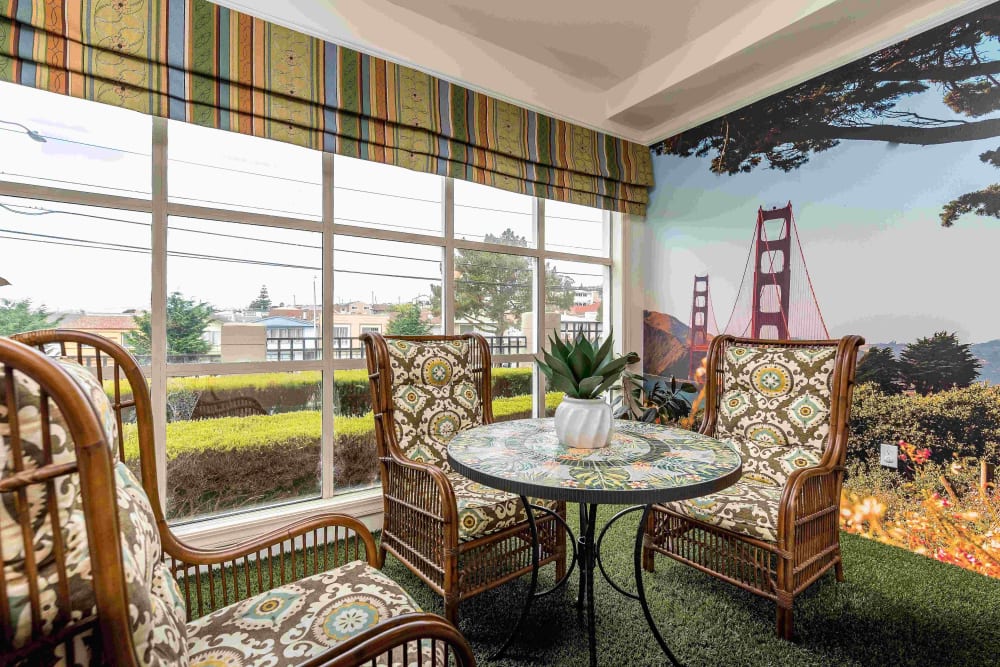 Seating area with round table at Pacifica Senior Living Mission Villa in Daly City, California