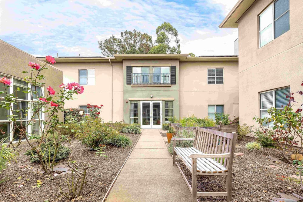 Outdoor walking paths and seating area at Pacifica Senior Living Mission Villa in Daly City, California