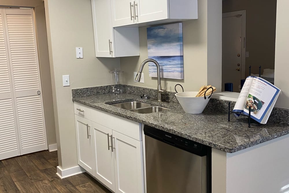 Fully equipped kitchen with white cabinetry and granite countertops at Lakeshore Reserve Off 86th in Indianapolis, Indiana