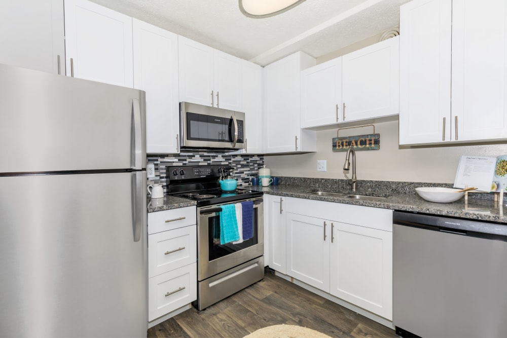 Modern kitchen with white cabinetry and stainless-steel appliances at The Boardwalk at Westlake in Indianapolis, Indiana