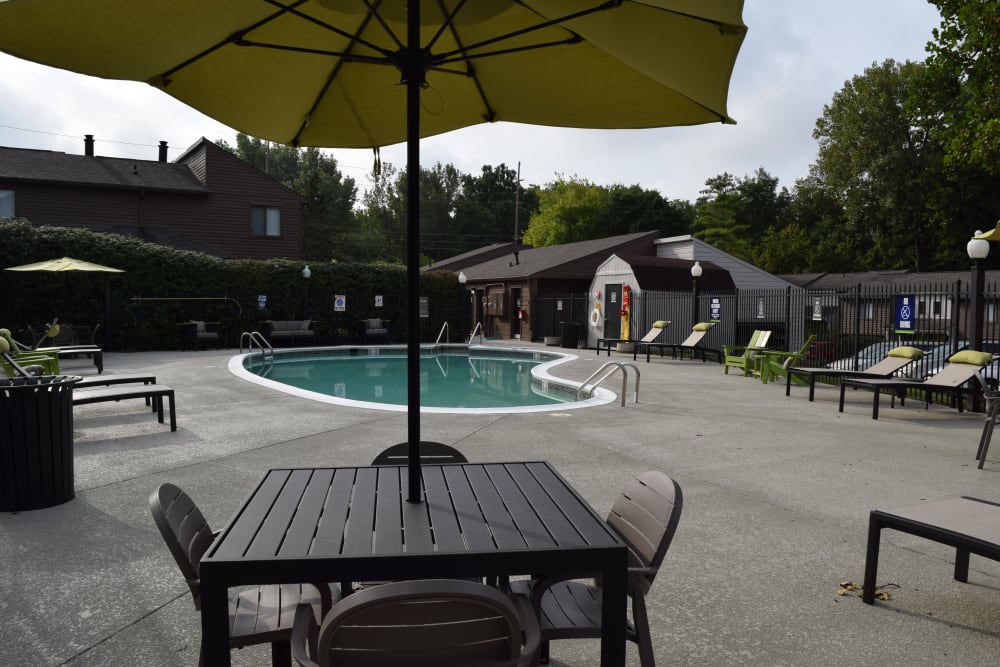 Swimming pool with sundeck patio tables and lounge chairs at The Preserve on Allisonville in Indianapolis, Indiana