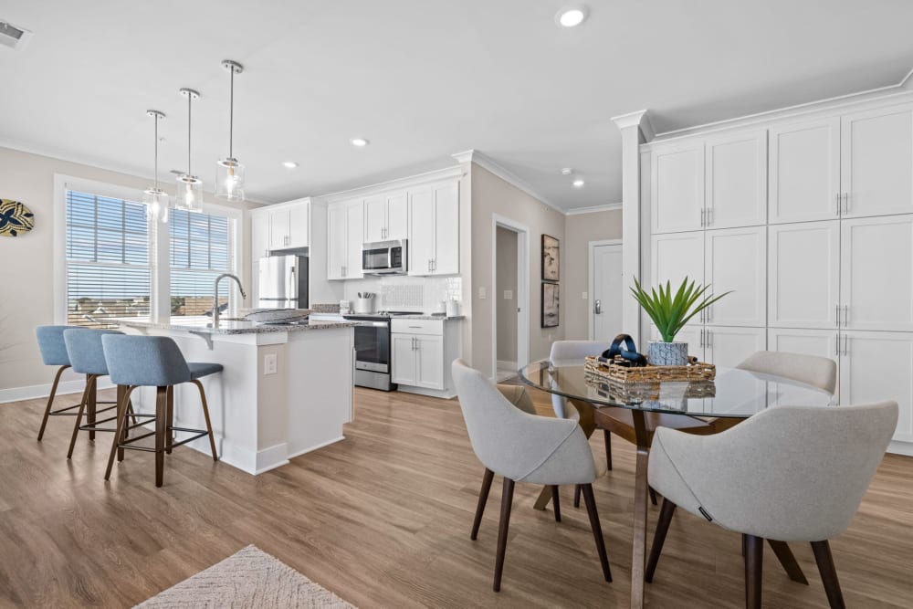 Dining table and spacious kitchen at Village Square Apartments in Norfolk, Virginia