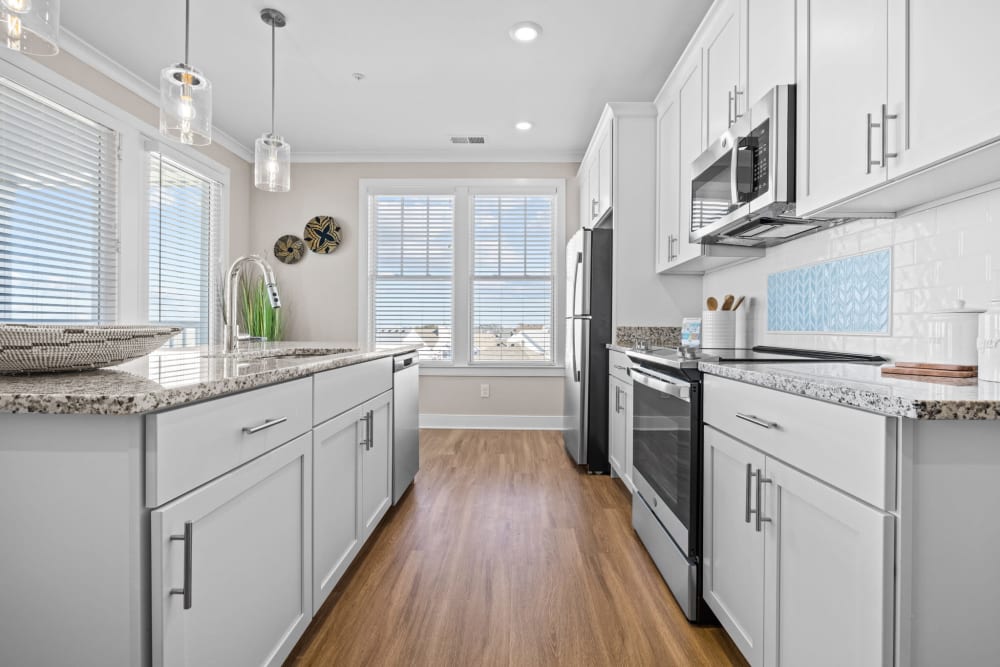 Kitchen with stainless-steel appliances at Village Square Apartments in Norfolk, Virginia