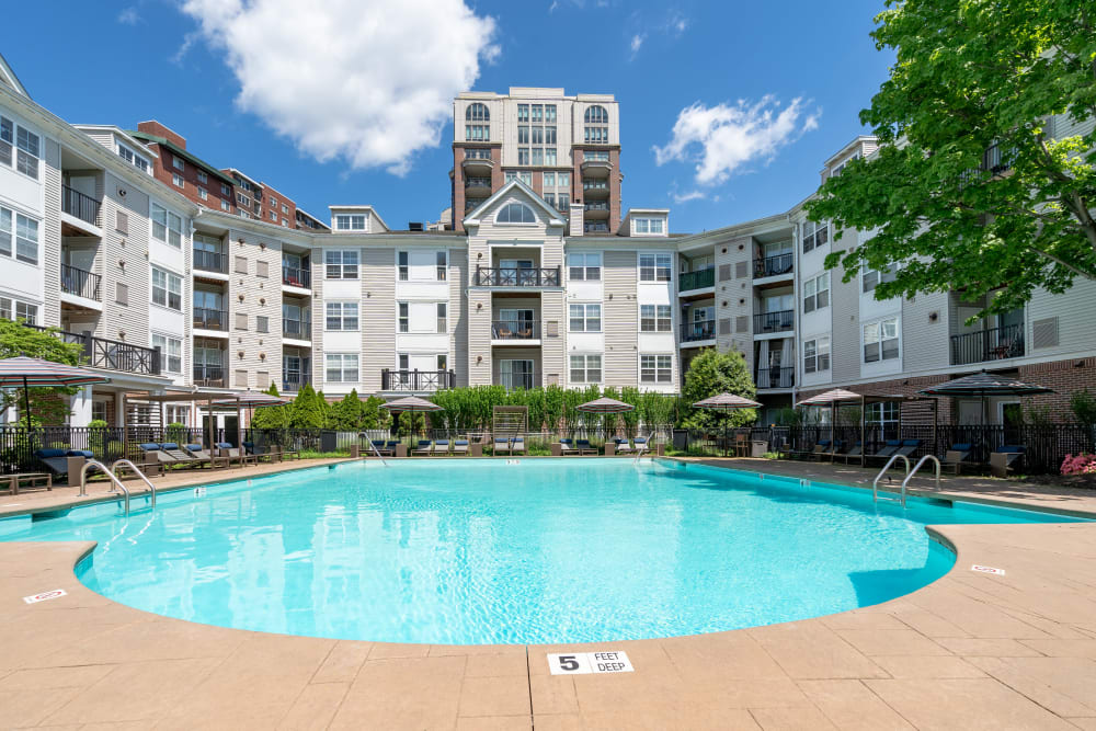 Aerial view of the community pool with the skyline in the distance at Sofi Parc Grove in Stamford, Connecticut