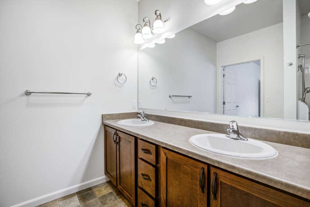 Double sinks in the bathroom of the main bedroom in an apartment at Meriwether Landing in Joint Base Lewis McChord, Washington