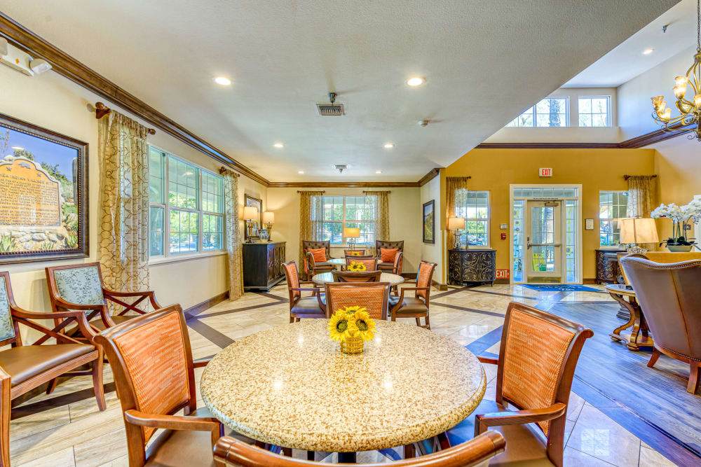 Tables and seating in the lounge area at Pacifica Senior Living Hemet in Hemet, California