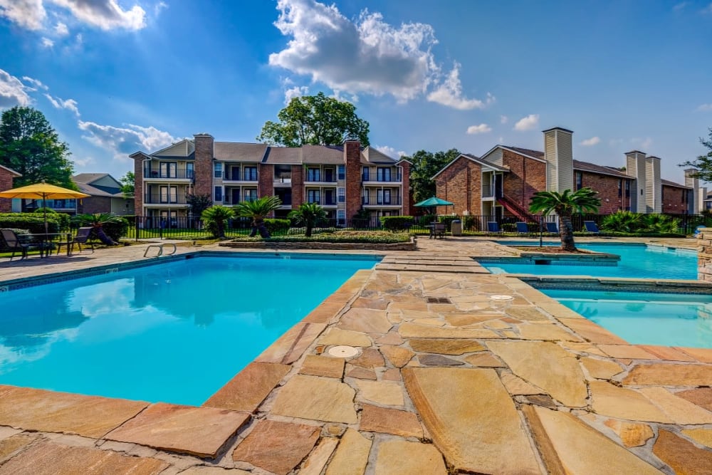 Outdoor swimming pool area at Peppertree Apartment Homes in Lafayette, Louisiana