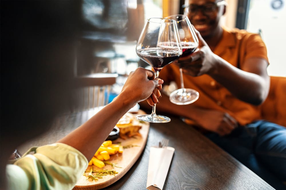 A couple toasting wine at The Park at Waterford Harbor in Kemah, Texas