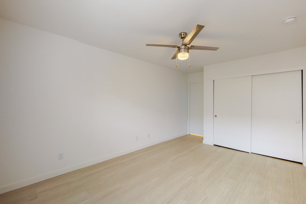 Bedroom with ceiling fan at Club Marina Apartments in Los Angeles, California