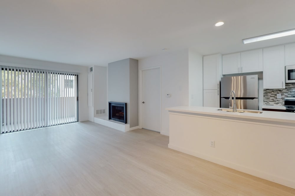 Spacious kitchen and living room with fireplace at Club Marina Apartments in Los Angeles, California