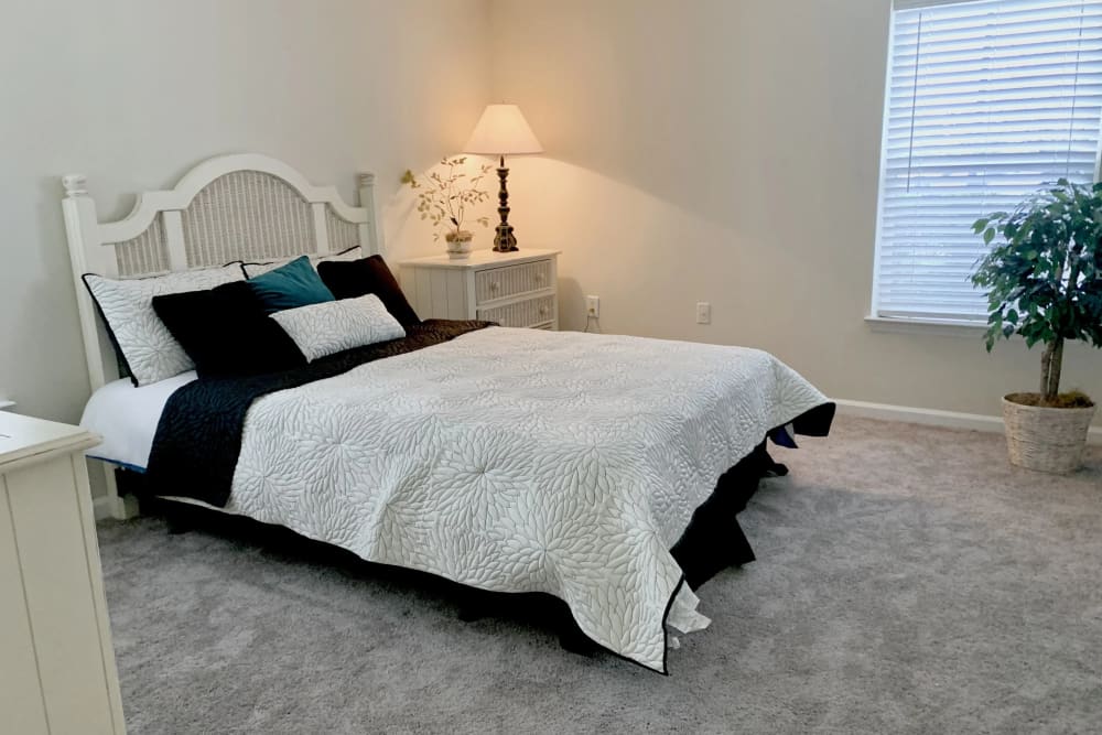Bedroom with plush carpeting at Fieldstone Apartment Homes in Mebane, North Carolina