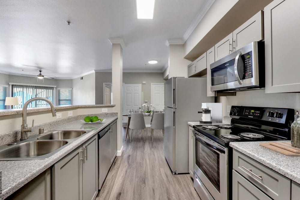 Grey Cabinetry Kitchen with wood-style flooring and stainless steel appliances at Avion Apartments in Rancho Cordova, California