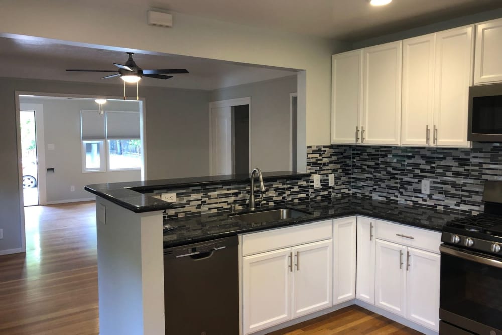 Kitchen with black appliances at Hawthorne Apartments in Palo Alto, California