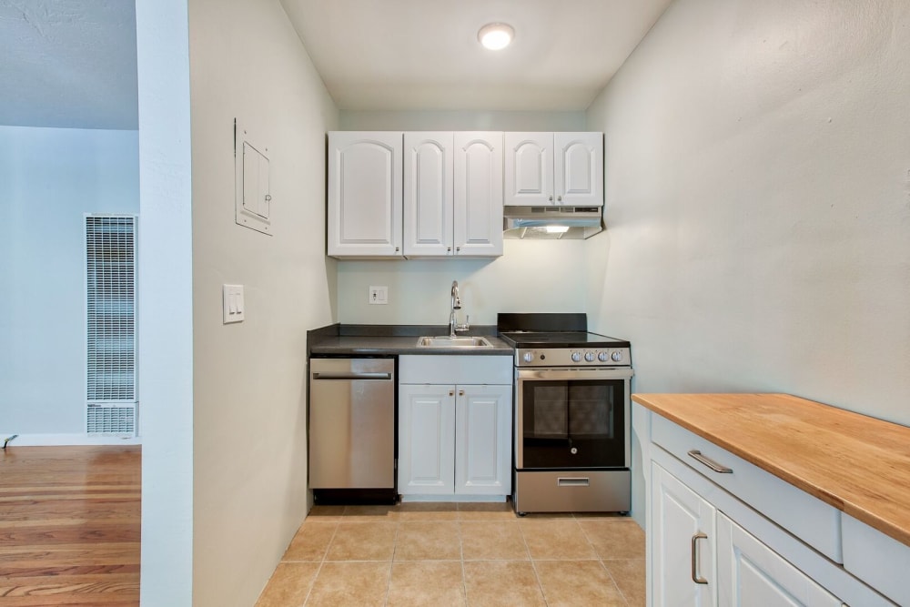 Kitchen with stainless-steel appliances at Hawthorne Apartments in Palo Alto, California