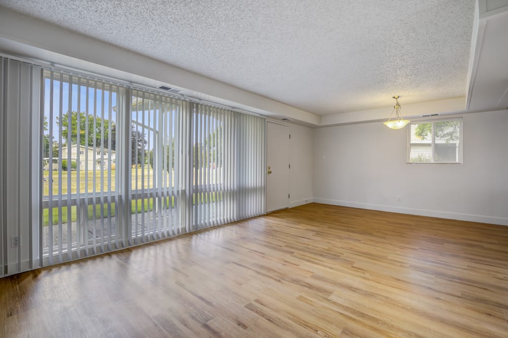 Spacious living room with large windows and wood floors at Clarkdale in Joint Base Lewis McChord, Washington