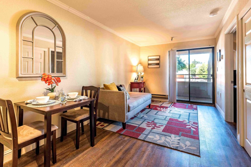 Dining area and living room in an apartment at Pacifica Senior Living San Leandro in San Leandro, California