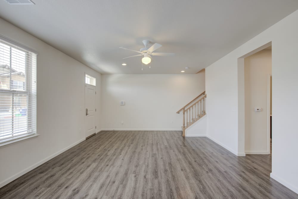 The living room with hardwood floors and large windows in Spacious kitchen with ample counter-space in an apartment at Blue Sky in Fallon, Nevada