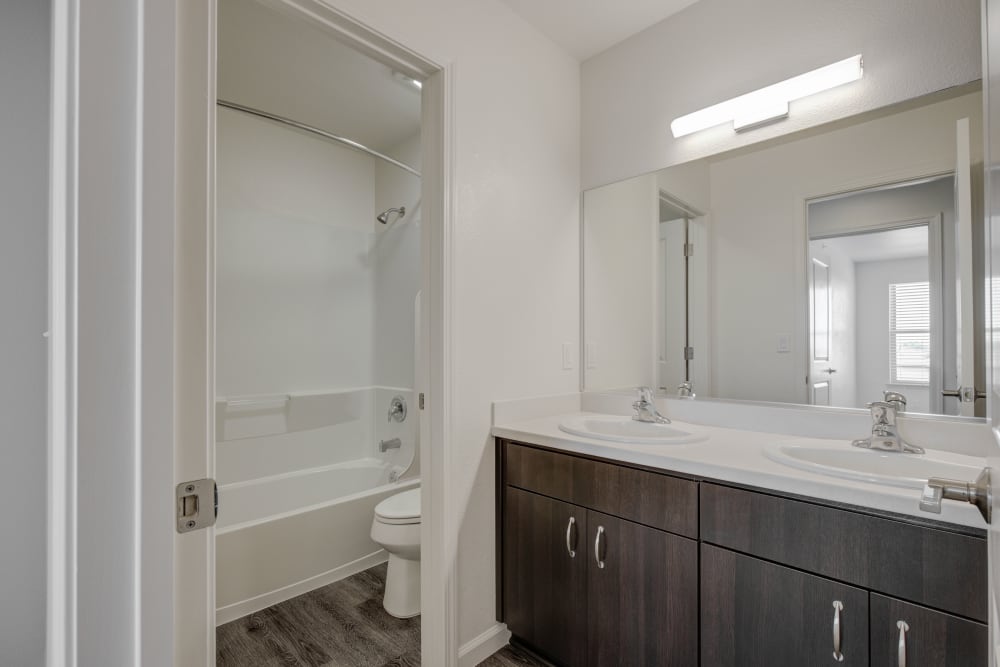 Bathroom with large vanity mirror and shower bathtub at Blue Sky in Fallon, Nevada