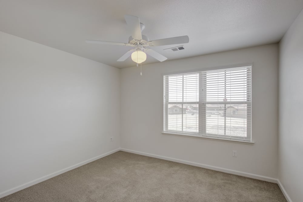 Spacious bedroom with ceiling fan and large windows for ample natural light at Blue Sky in Fallon, Nevada