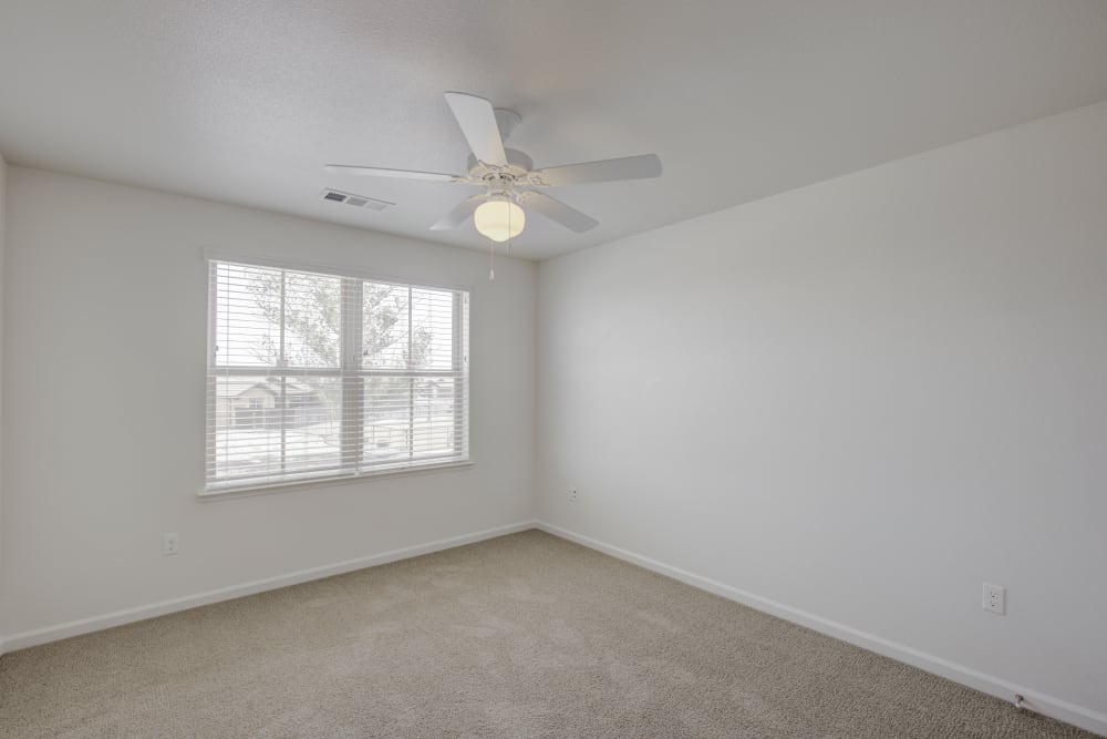 Spacious bedroom with ceiling fan and large windows Spacious kitchen with ample counter-space in an apartment at Blue Sky in Fallon, Nevada