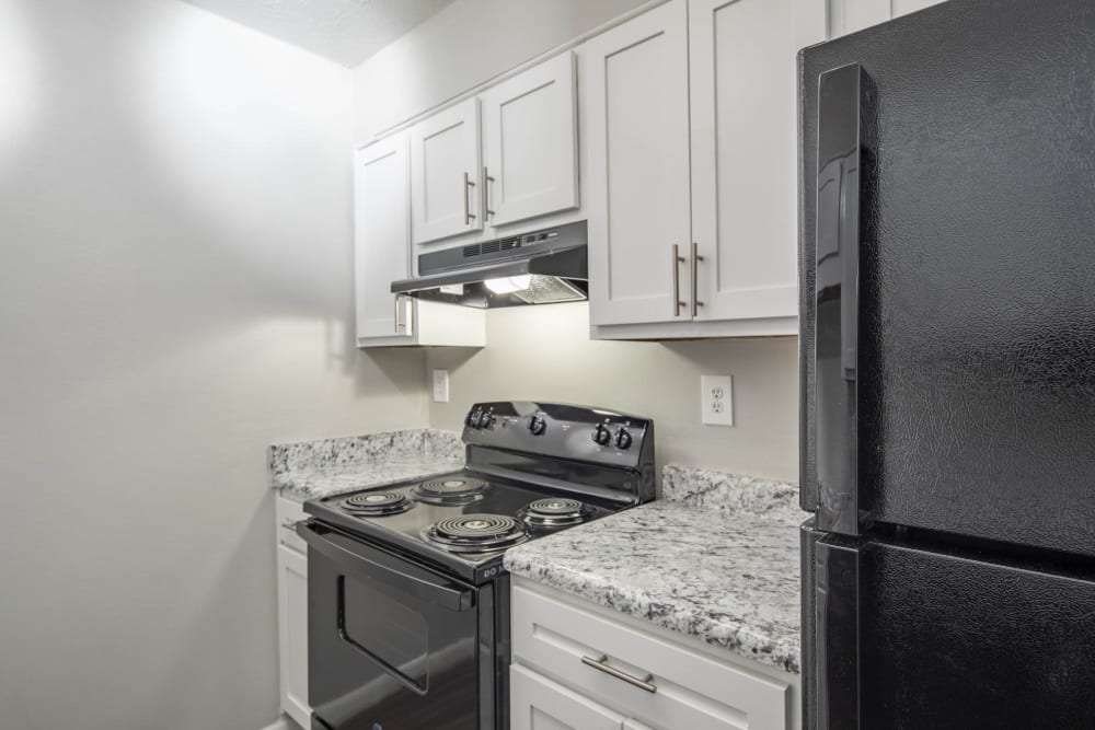 Kitchen with black amenities at Eastdale Apartments in Montgomery, Alabama
