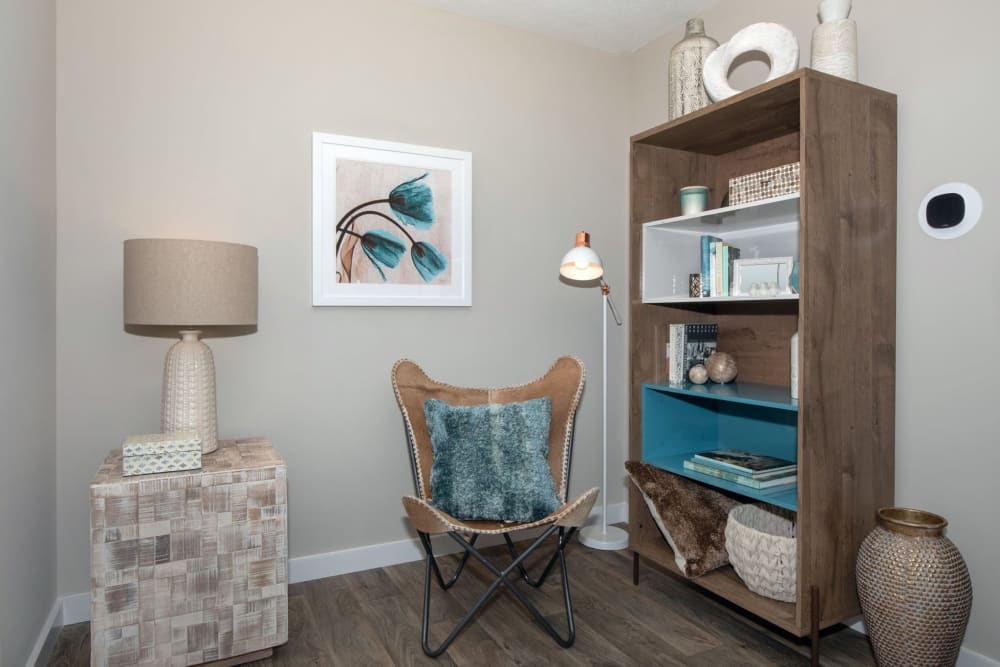 Comfy chair and bookcase in a bedroom at Parkside at Castleton Square in Indianapolis, Indiana