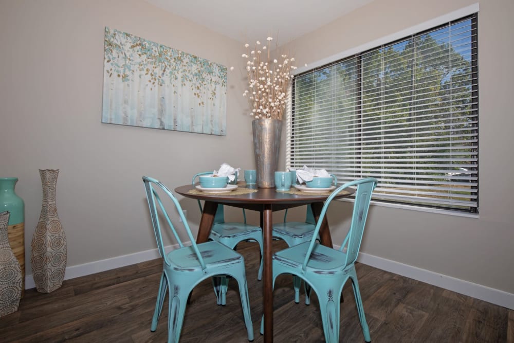 Dining area of a model home with wood-style flooring at Parkside at Castleton Square in Indianapolis, Indiana