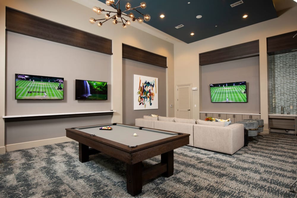 Pool table and TVs in the luxury clubhouse at Olympus at Memorial in Houston, Texas