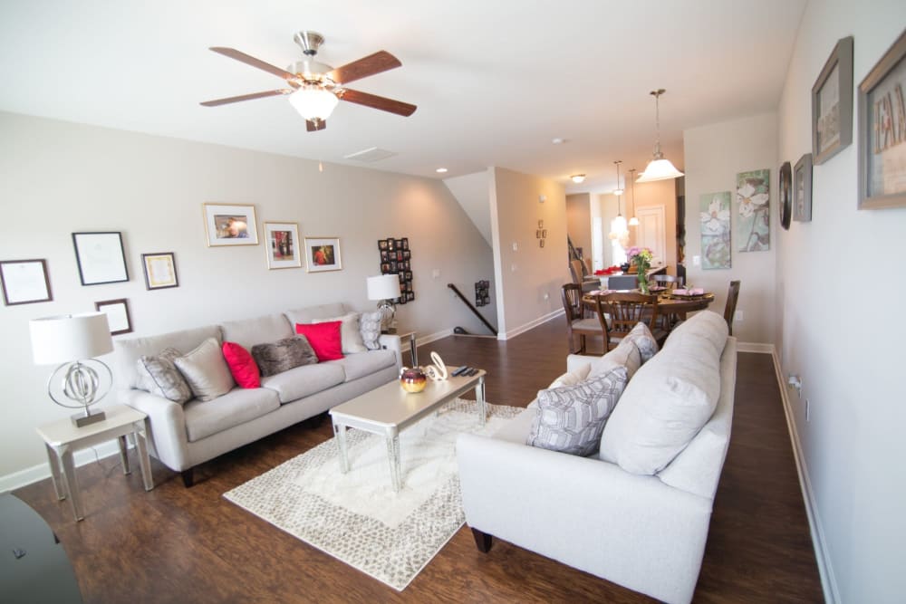 Modern living room with beautiful brown hardwood flooring at Charleston Row Townhomes in Pineville, North Carolina