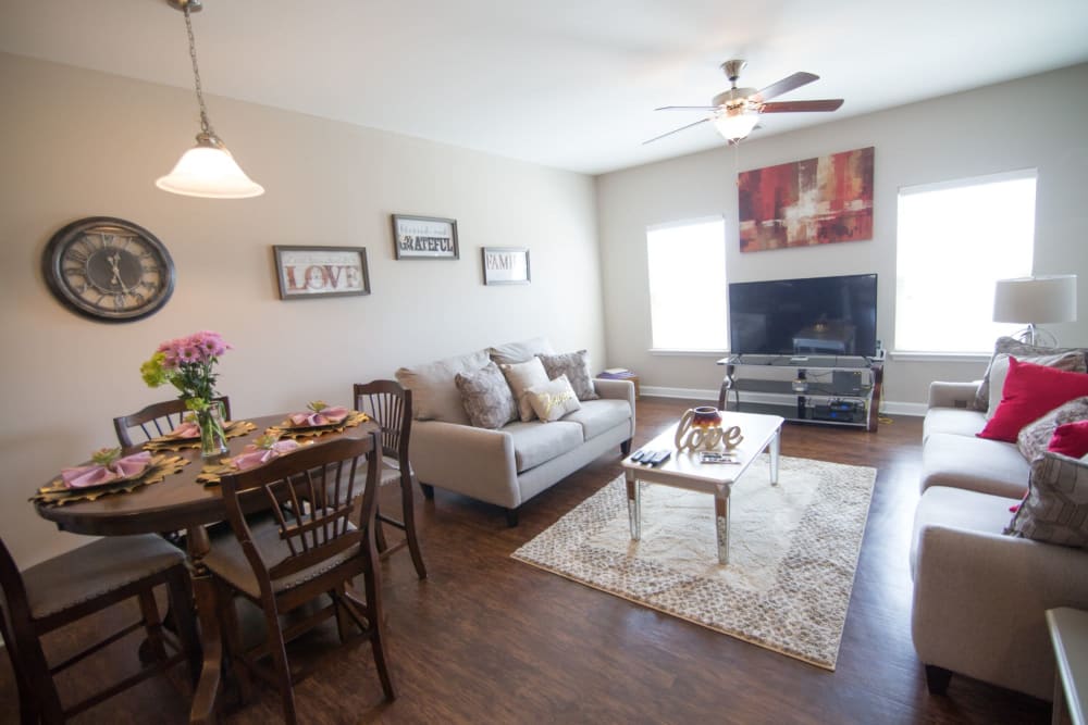 Living room with a wood dining table at Charleston Row Townhomes in Pineville, North Carolina
