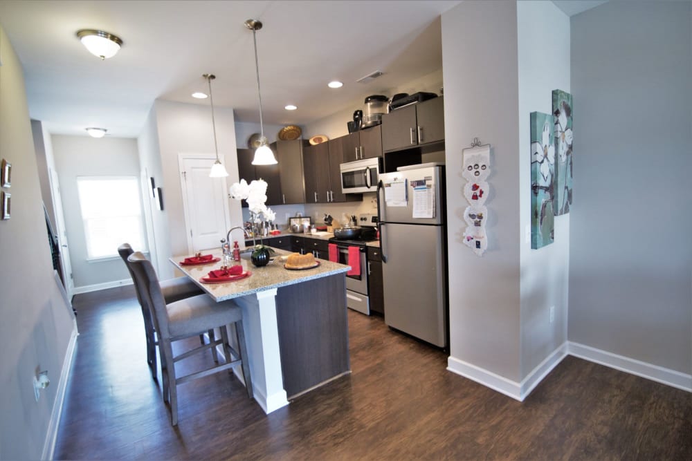 Kitchen area with barstool seating at Charleston Row Townhomes in Pineville, North Carolina