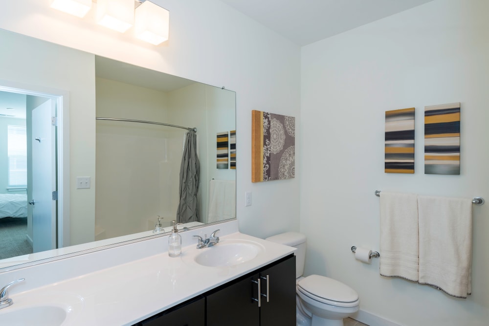 Model bathroom with large mirror at Element at Ghent in Norfolk, Virginia