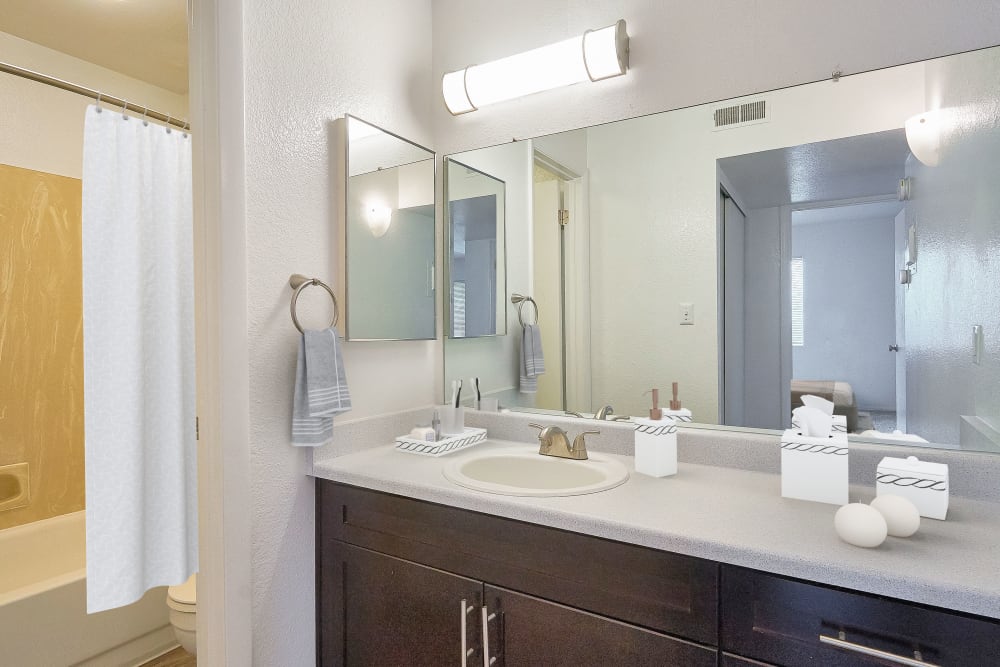 Renovated bathroom with lots of counter space and a large mirror at Callaway Apartments in Taylorsville, Utah
