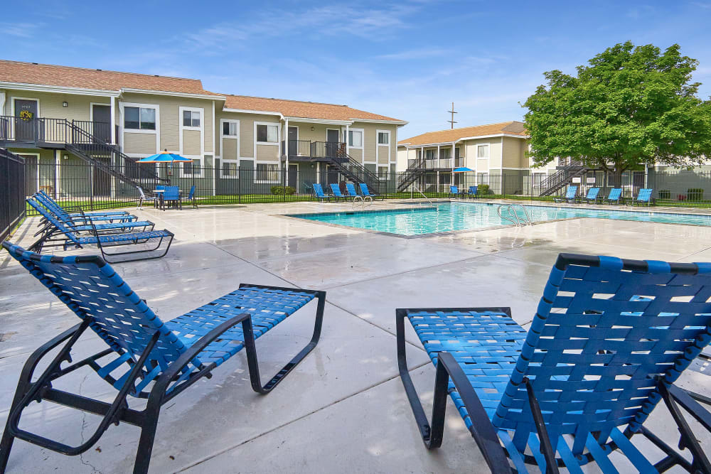 Beautiful resort-style swimming pool with a lush backdrop at Callaway Apartments in Taylorsville, Utah