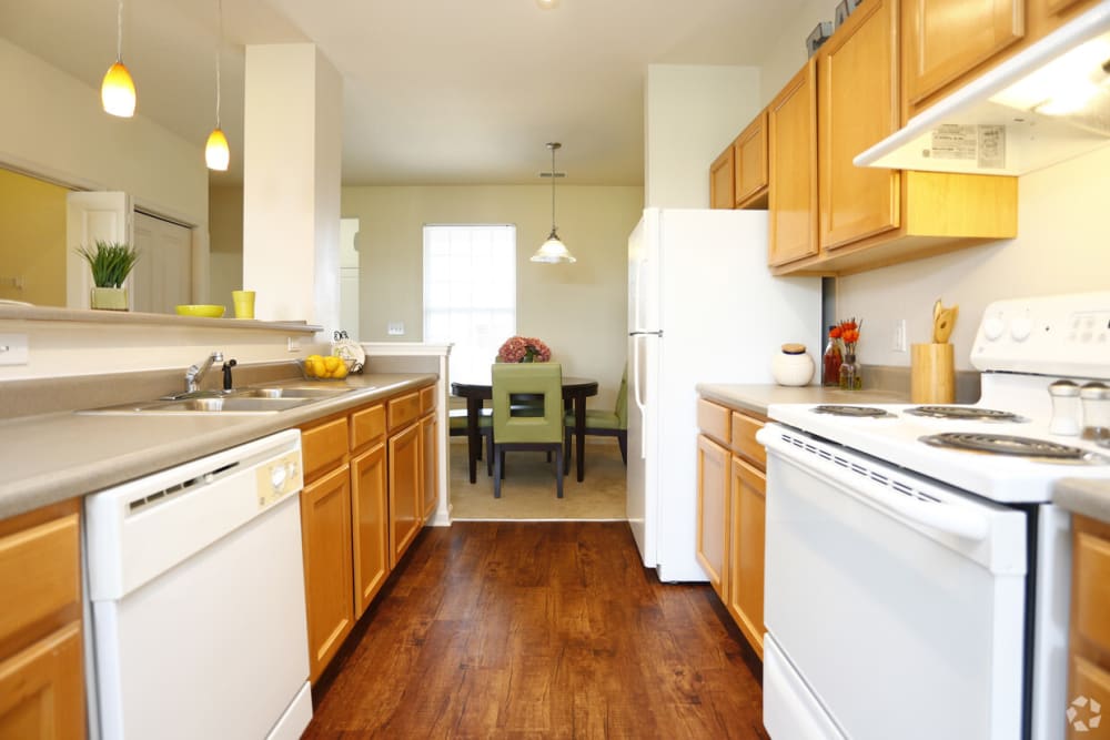 Resident kitchen with wood style flooring at Watersedge in Champaign, Illinois