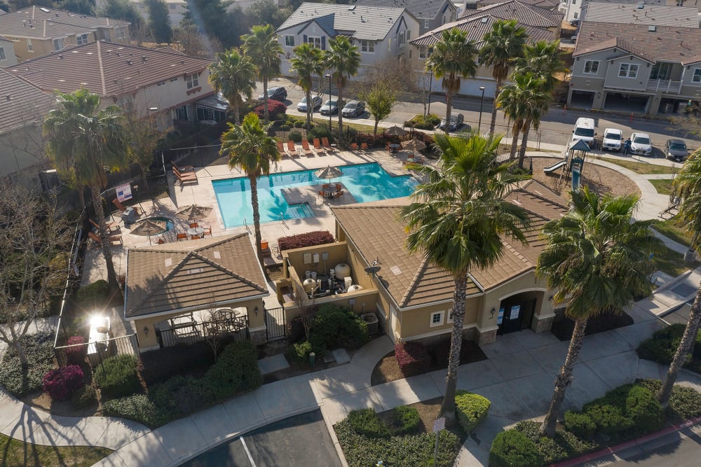 Overhead drone photo of apartment complex and pool at Parador Townhomes in Clovis, California