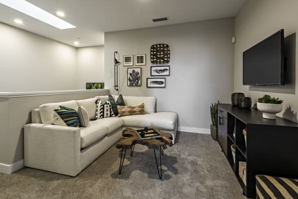 Living room with large couch and entertainment center at Parador Townhomes in Clovis, California