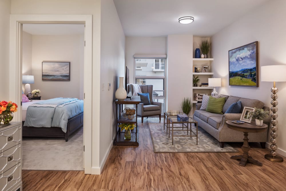 An apartment bedroom and living room at The Village at The Triangle in Austin, Texas