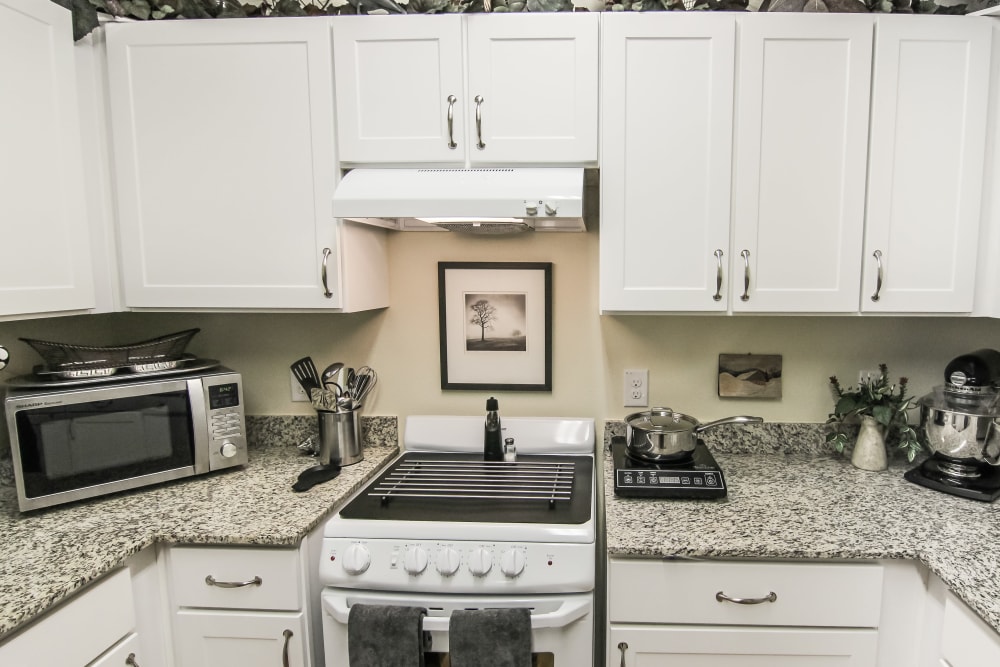 Granite counter tops in an apartment kitchen at Village on the Park Onion Creek in Austin, Texas