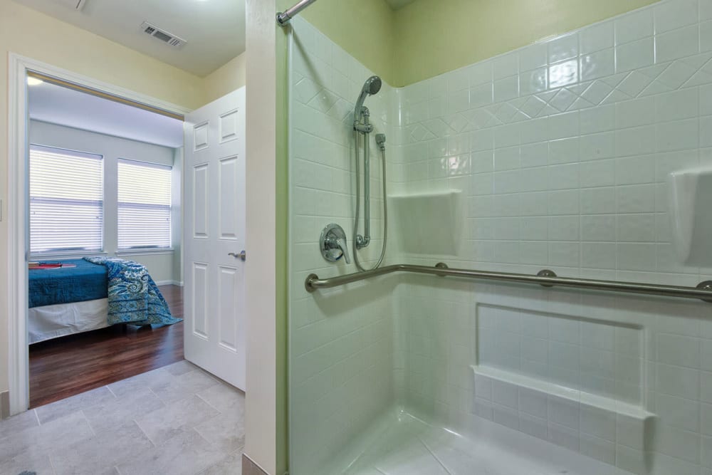 An apartment shower in the bathroom attached to the bedroom at The Village of the Heights in Houston, Texas