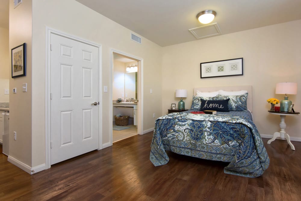 A spacious bedroom with wood flooring at The Village of the Heights in Houston, Texas